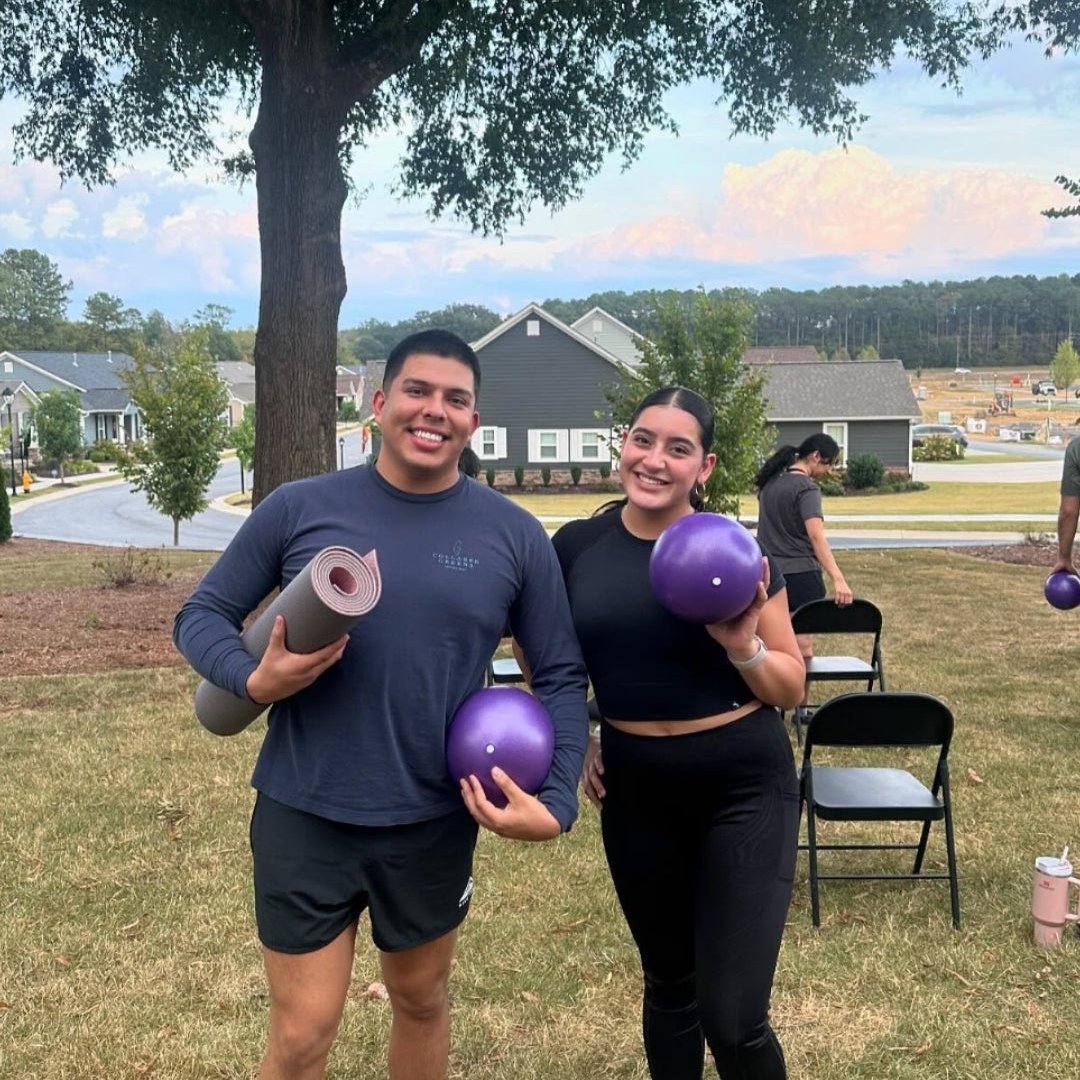 Two people outdoors with exercise equipment on a grassy area. Dalton, GA